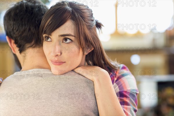 Hispanic woman hugging boyfriend