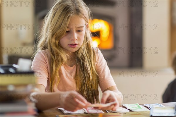 Caucasian girl playing cards