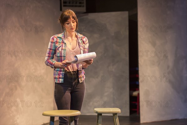 Hispanic actress rehearsing on theater stage