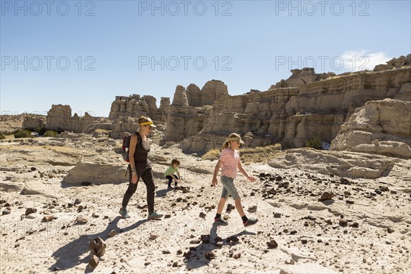 Caucasian mother and children hiking in desert