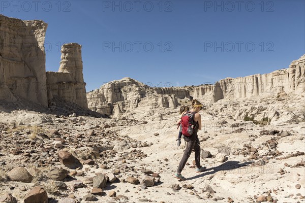 Caucasian mother and son hiking in desert