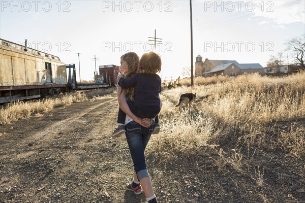 Caucasian girl carrying brother piggyback