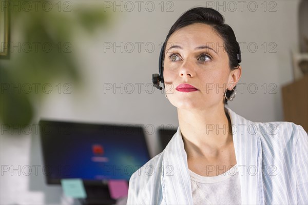 Businesswoman wearing headset in office