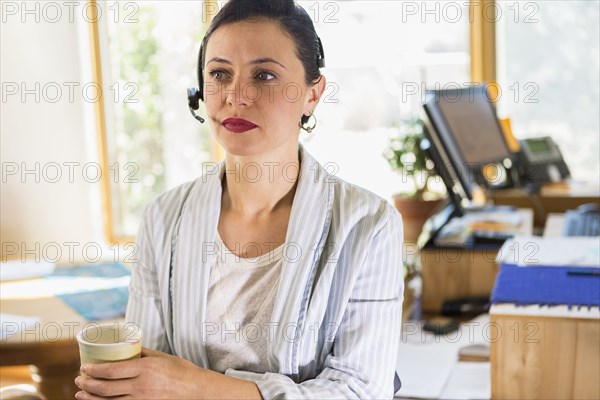 Businesswoman wearing headset in office