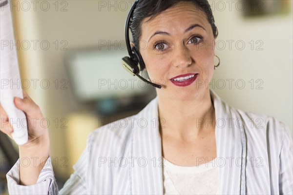 Businesswoman talking on headset in office