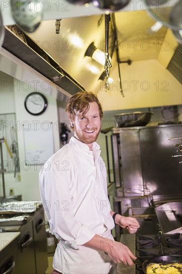 Caucasian chef cooking in restaurant kitchen