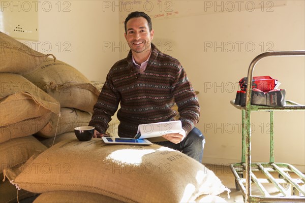 Hispanic entrepreneur using digital tablet in store