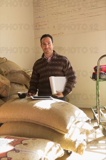 Hispanic entrepreneur using digital tablet in store