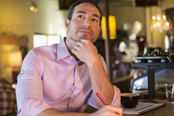 Hispanic businessman working in coffee shop