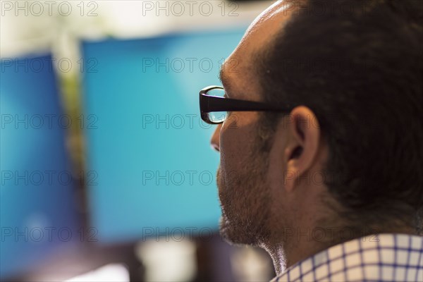 Hispanic businessman using computer in office