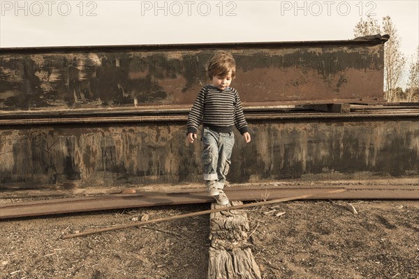 Caucasian boy walking on wall