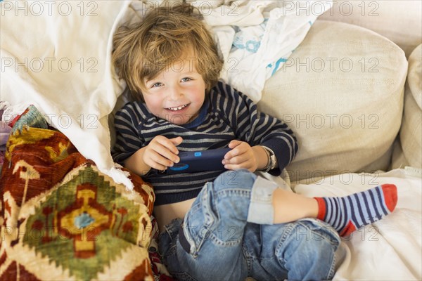 Caucasian boy laying on sofa