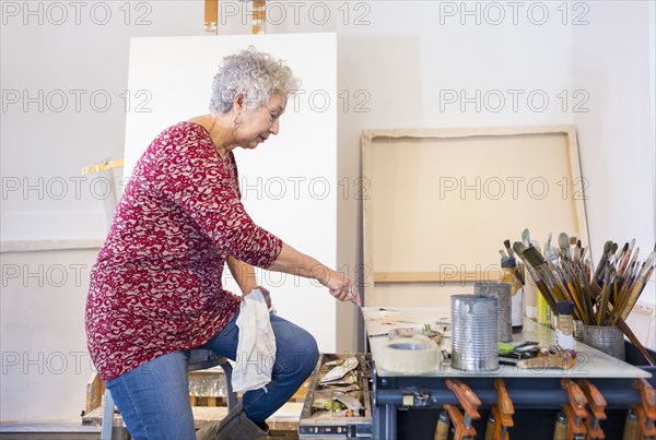 Artist painting in studio