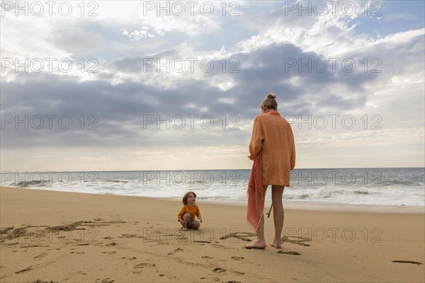 Caucasian mother and son on beach