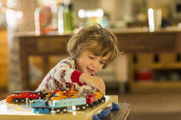 Caucasian boy playing with toy trains