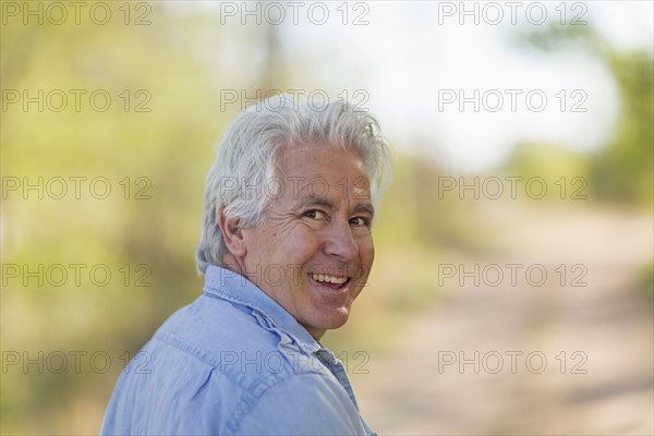 Caucasian man looking over shoulder