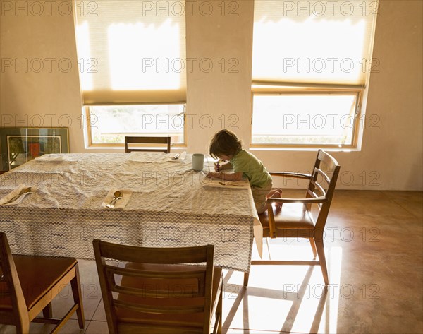 Caucasian boy drawing at table