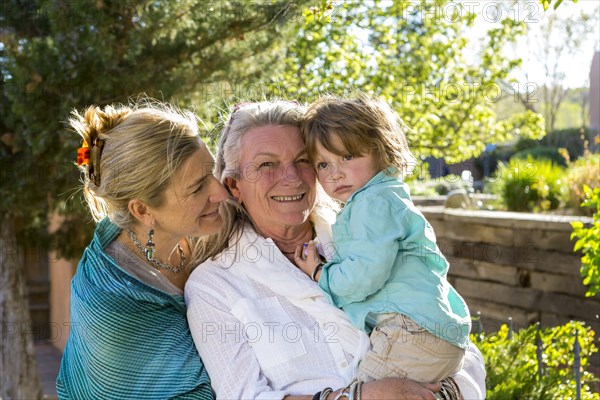 Smiling Caucasian multi-generation family posing outdoors