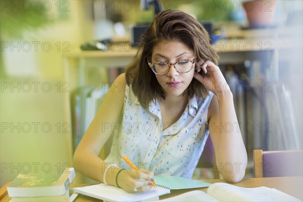 Mixed Race girl studying in library