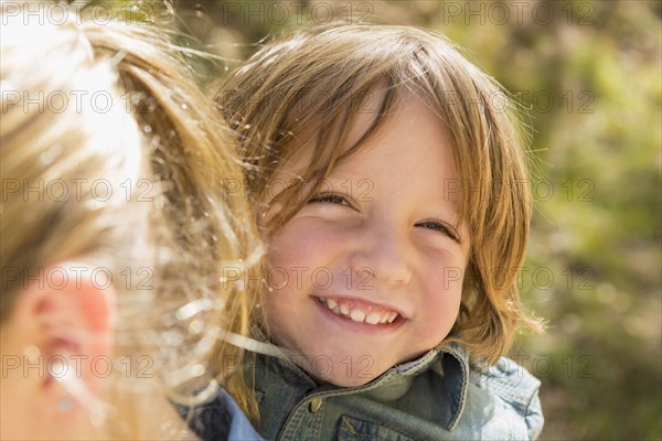 Portrait of Caucasian boy smiling behind sister