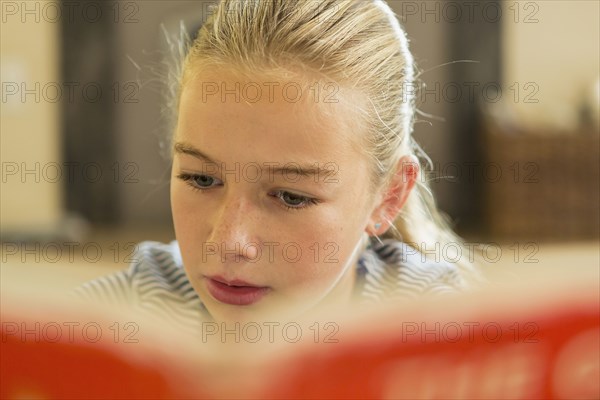 Caucasian girl reading book