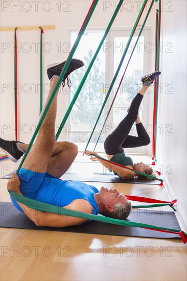 People using resistance bands in gymnasium