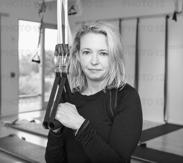 Portrait of Caucasian woman holding handles of resistance bands