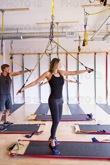 People using resistance bands in gymnasium