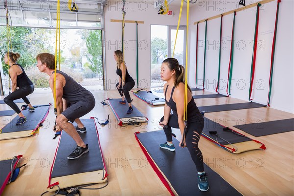 People using resistance bands in gymnasium