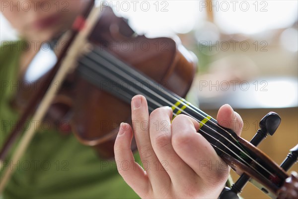 Close up of Caucasian girl playing violin