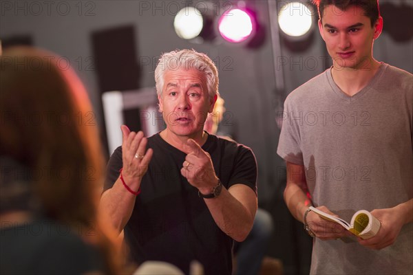 Teacher talking to students in theater class