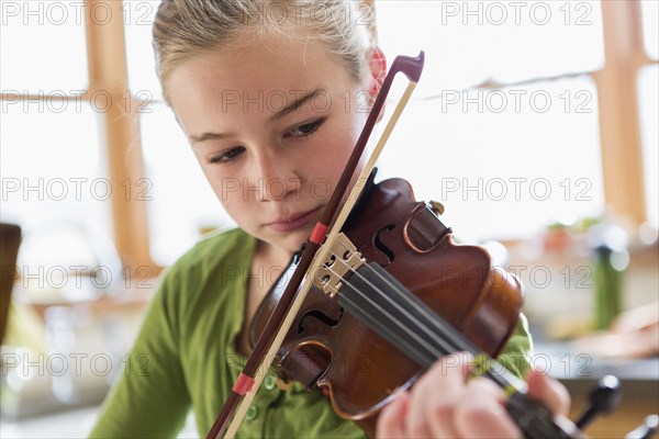 Close up of Caucasian girl playing violin