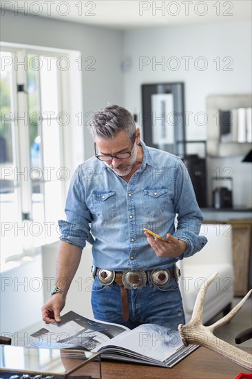 Caucasian man holding staircase reading book