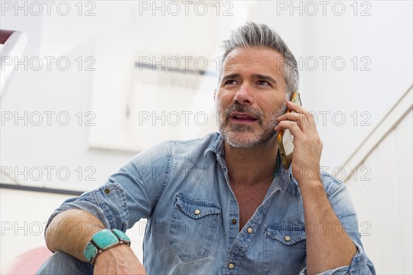 Caucasian man talking on cell phone