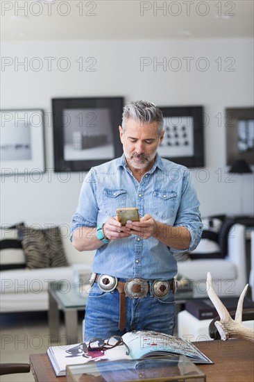 Caucasian man texting on cell phone