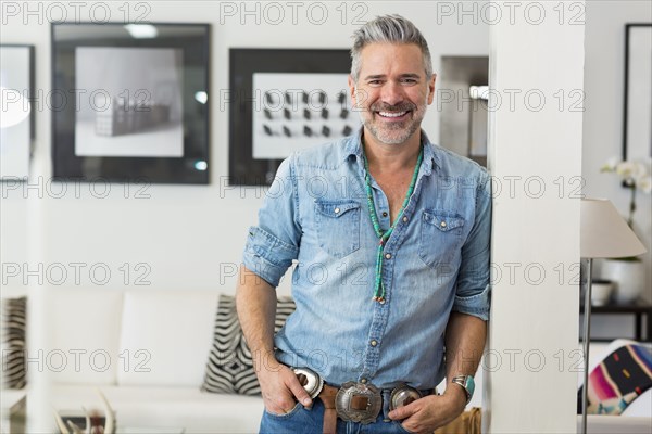 Smiling Caucasian man leaning on pillar