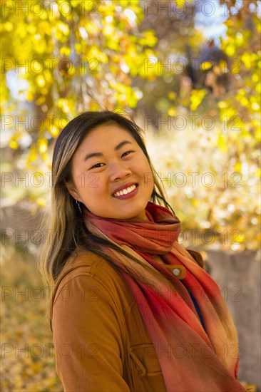 Portrait of smiling Asian woman in autumn
