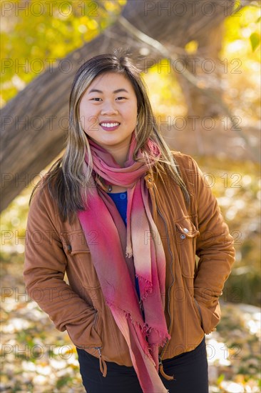 Portrait of smiling Asian woman in autumn