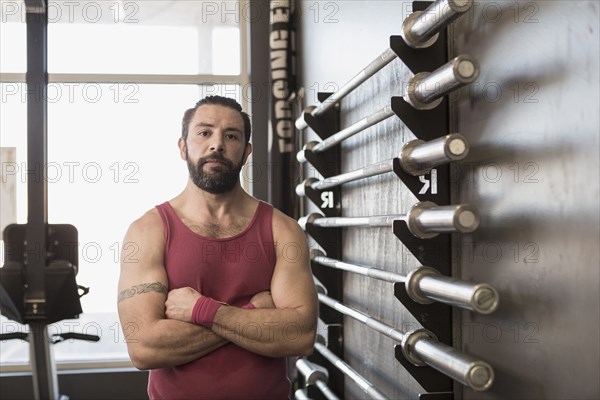 Portrait of serious Mixed Race man posing in gymnasium