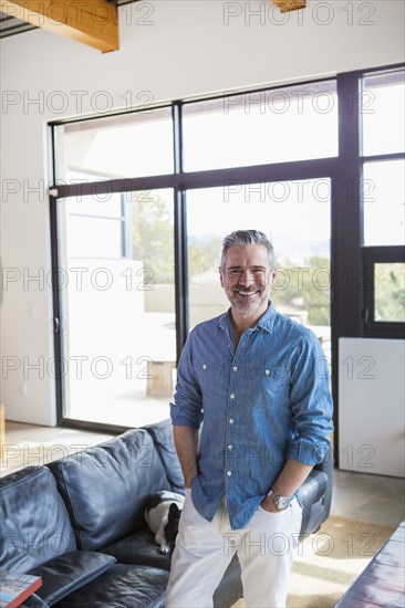 Portrait of smiling Caucasian man in livingroom