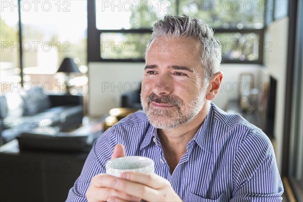 Caucasian man drinking coffee and daydreaming