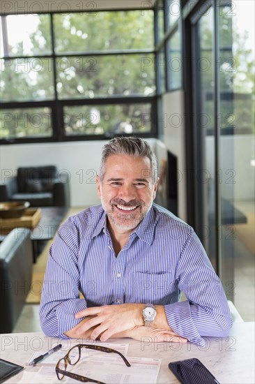 Portrait of smiling Caucasian man sitting at table