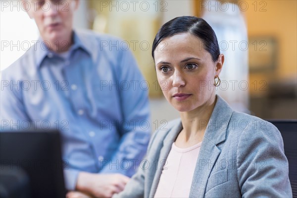 Caucasian business people using computer