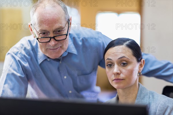 Caucasian business people reading computer