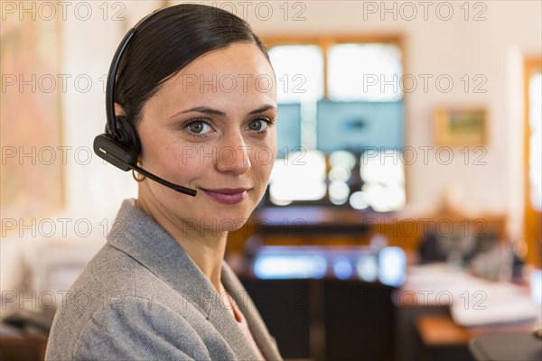 Portrait of smiling Caucasian businesswoman wearing headset