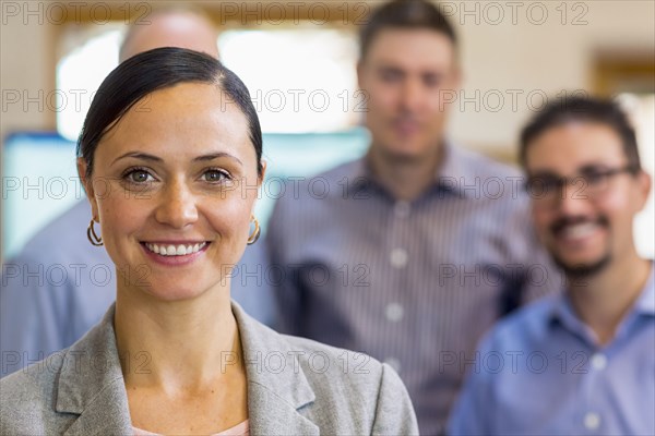 Portrait of smiling businesswoman and team