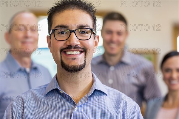 Portrait of smiling businessman and team