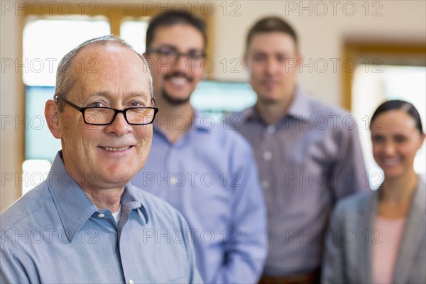 Portrait of smiling businessman and team