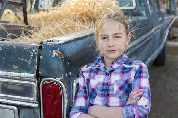 Caucasian girl leaning on truck