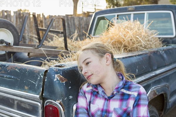 Caucasian girl leaning on truck